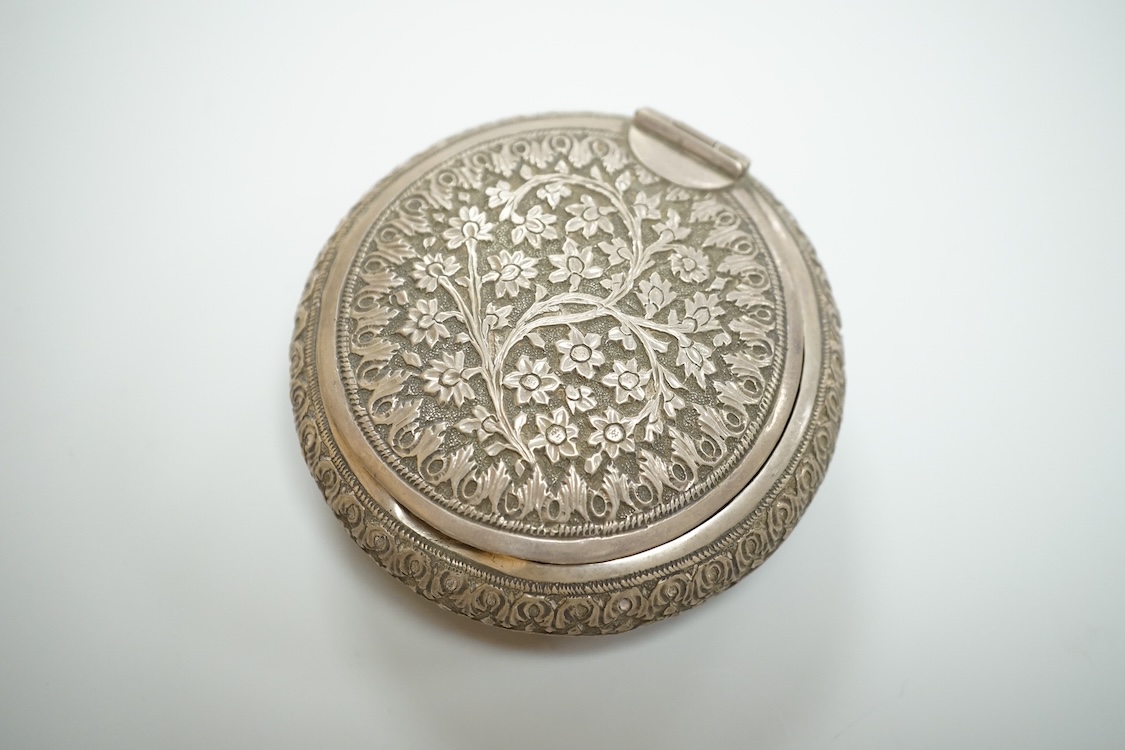 A Thai white metal tobacco box, embossed with foliage, diameter 72mm together with a similar dish.
